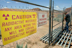 U.S. Energy Corp. resident project manager Daryl Winters locks the gate, on July 12, 2006, at the Shootaring Mill north of Ticaboo, Utah.