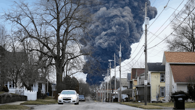 A black plume rises over East Palestine, Ohio, as a result of a controlled detonation of a portion of the derailed Norfolk Southern trains Monday, Feb. 6, 2023.