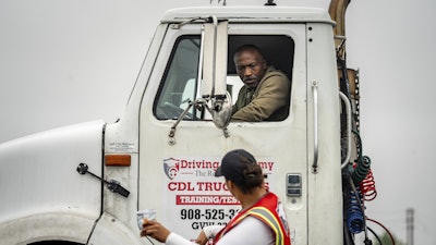 An instructor talks to a student at the Driving Academy, June 10, 2025, Linden, N.J.