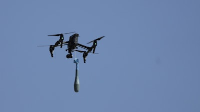A drone carries a mortar shell as soldiers take part in the U.S.-led Immediate Response 25 military exercise in Petrochori, Greece, Wednesday, June 4, 2025.