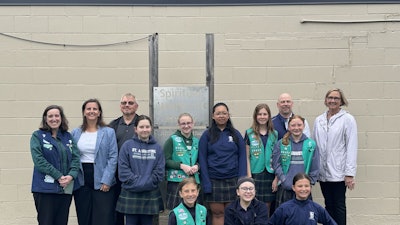 Girl Scout Troop Leader Maureen Yanik, LKF Marketing Vice President Sarah Morgan, Unifab CEO Rob Thayer, Girl Scout Troop 80452, Unifab President Matt Hill and St. Augustine Cathedral School Principal Andra Zommers at the unveiling of the signs (from left to right).