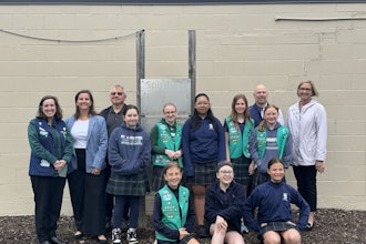 Girl Scout Troop Leader Maureen Yanik, LKF Marketing Vice President Sarah Morgan, Unifab CEO Rob Thayer, Girl Scout Troop 80452, Unifab President Matt Hill and St. Augustine Cathedral School Principal Andra Zommers at the unveiling of the signs (from left to right).