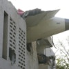 The debris of an airplane sticks out of a building after it crashed in India's northwestern city of Ahmedabad in Gujarat state, Thursday, June 12, 2025.