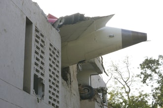 The debris of an airplane sticks out of a building after it crashed in India's northwestern city of Ahmedabad in Gujarat state, Thursday, June 12, 2025.