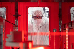 An employee monitors a wafer transfer at one of Texas Instruments’ 300mm semiconductor fabs in Sherman, Texas, SM1.