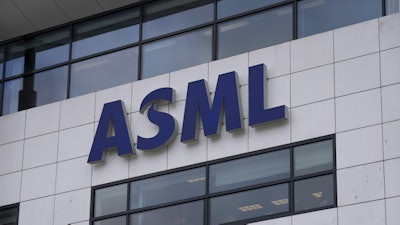 The logo of ASML, a leading maker of semiconductor production equipment, hangs on the head office in Veldhoven, Netherlands, on Jan. 30, 2023.
