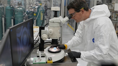 Taylor Duffin, of TRISO-X, a subsidiary of X-Energy, looks at a sample of TRISO fuel through a microscope Friday, June 27, 2025, in Oak Ridge, Tenn.