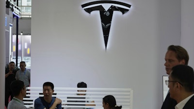 Visitors at the Tesla booth during the 3rd China International Supply Chain Expo at the China International Exhibition Center, in Beijing, China, Friday, July 18, 2025.