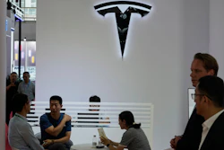 Visitors at the Tesla booth during the 3rd China International Supply Chain Expo at the China International Exhibition Center, in Beijing, China, Friday, July 18, 2025.