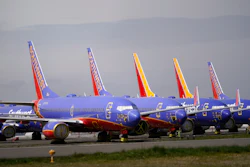 A line of Southwest Air Boeing 737 jets are parked near the company's production plant while being stored at Paine Field Friday, April 23, 2021, in Everett, Wash.