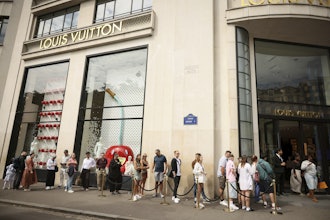 People queue outside the Louis Vuitton store, Paris, July 28, 2025.