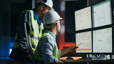 Group of operators control process on product line.