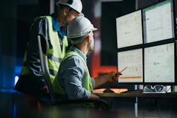Group of operators control process on product line.