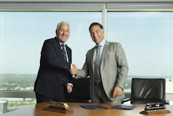 In this photo provided by Union Pacific shows from left, Union Pacific CEO Jim Vena shakes hands with Norfolk Southern CEO Mark George at the meeting where both men signed the agreement to merge the two railroads they lead to create the first transcontinental railroad in the United States on Monday, July 28, 2025 in Omaha, Neb.