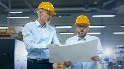 Two Employees At Logistics Center Warehouse Talk About The Plan On White Paper 838527590 3440x1935 (1)