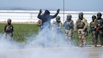 ederal immigration agents toss tear gas at protesters during a raid in the agriculture area of Camarillo, Calif., Thursday, July 10, 2025.