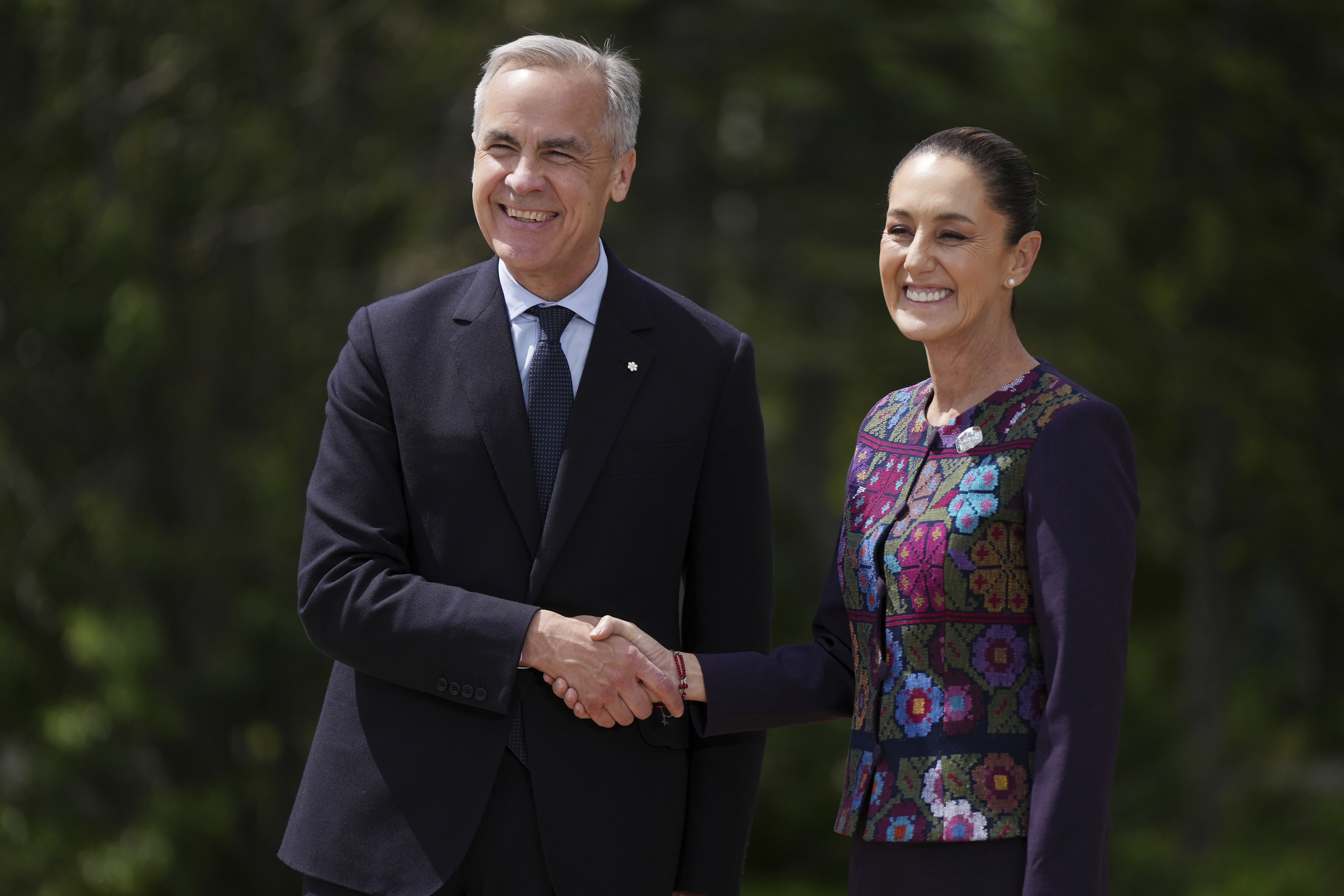 Canada's Prime Minister Mark Carney welcomes Mexican President Claudia Sheinbaum to the G7 Summit in Kananaskis, Alberta, June 17, 2025.