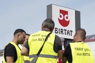 Strikers stand in front of the Birtat factory in Murr, Germany, Wednesday, Aug. 6, 2025.