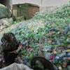 A female worker sorts through empty bottles at a plastic recycling factory in Lahore, Pakistan, Thursday, Aug. 7, 2025.