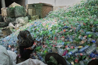 A female worker sorts through empty bottles at a plastic recycling factory in Lahore, Pakistan, Thursday, Aug. 7, 2025.