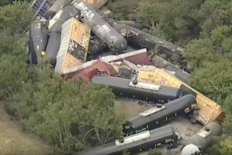 In this image from video by WFAA, train cars are piled up off the track after a derailment near Gordon, Texas, Aug. 12, 2025.