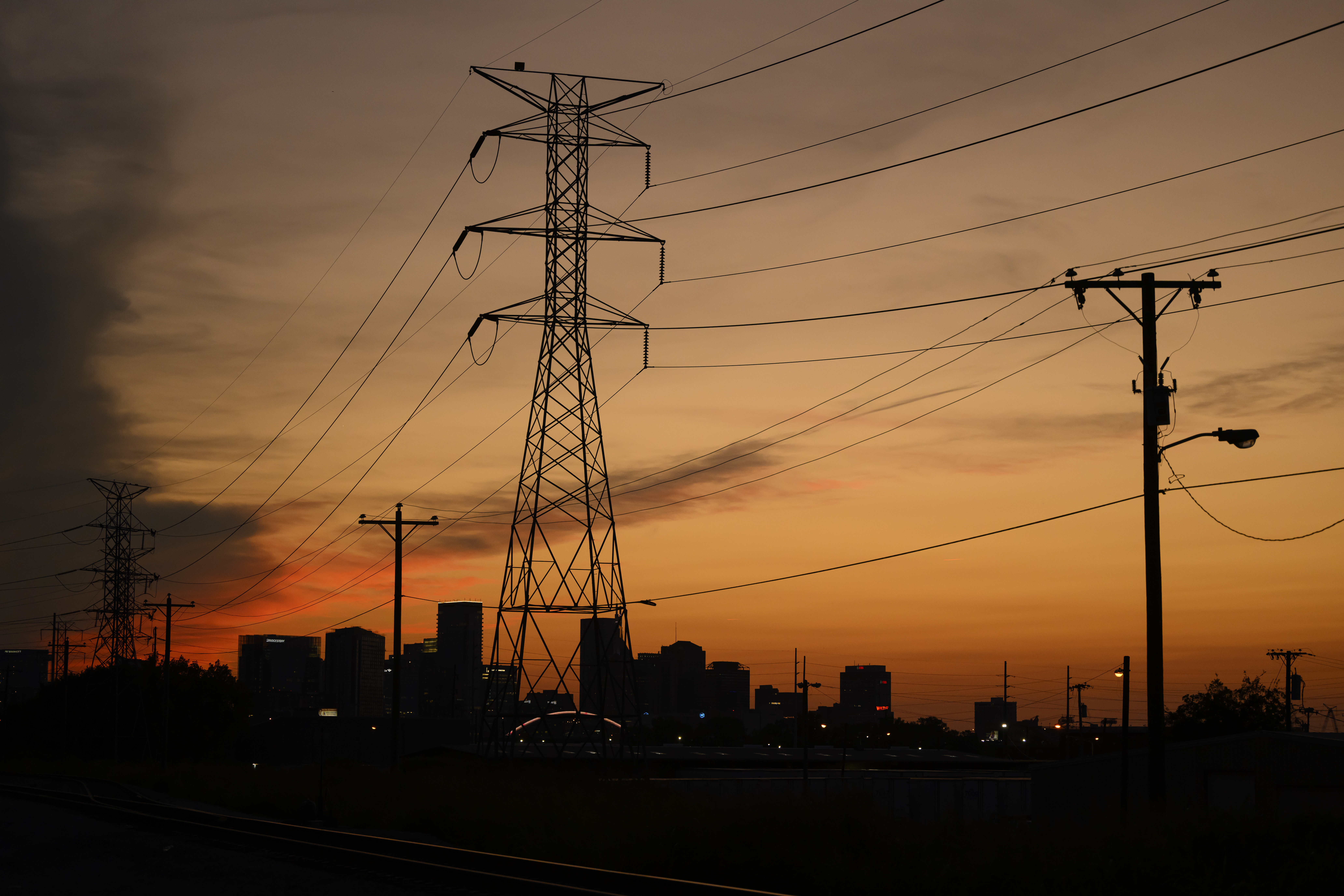 Electrical power lines string across the landscape near downtown Sunday, Aug. 11, 2024, in Nashville, Tenn.