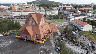 On a specially designed trolley with 224 wheels, Kiruna Church is moved for relocation at a speed of half a kilometer per hour, in Kiruna, Sweden, Tuesday Aug. 19, 2025.