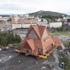 On a specially designed trolley with 224 wheels, Kiruna Church is moved for relocation at a speed of half a kilometer per hour, in Kiruna, Sweden, Tuesday Aug. 19, 2025.