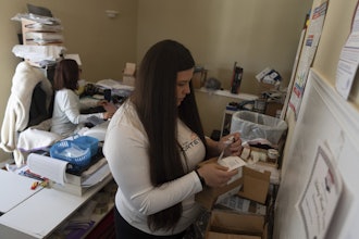 Amanda Follett works on packages at A Sight For Sport Eyes, a brick-and-mortar and e-commerce store for sport goggles, Aug. 20, 2025, in West Linn, Ore.