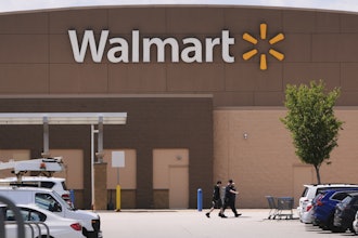 Shoppers walk from the Walmart store, Aug. 14, 2025, in Manchester, N.H.