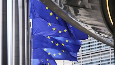 European Union flags flap in the wind outside EU headquarters in Brussels, Thursday, Aug. 21, 2025.