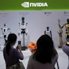 Visitors give commands to a robot at Nvidia's booth during the 3rd China International Supply Chain Expo at the China International Exhibition Center, in Beijing, July 18, 2025.