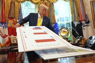 President Donald Trump holds charts as he speaks about the economy in the Oval Office, Aug. 7, 2025.