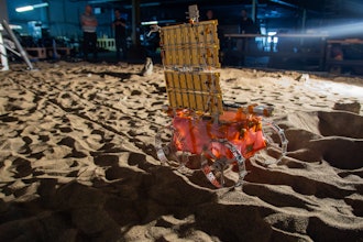 LunaGrid-Lite deploys an ultralight cable across a mobility test lab at Astrobotic as engineers monitor its progress.