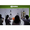 Visitors give commands to a robot at Nvidia's booth during the 3rd China International Supply Chain Expo at the China International Exhibition Center, in Beijing, July 18, 2025.