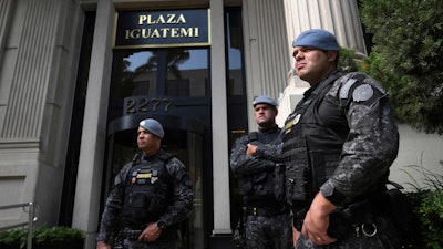 Police stand guard in front of a building in Sao Paulo, Aug. 28, 2025.