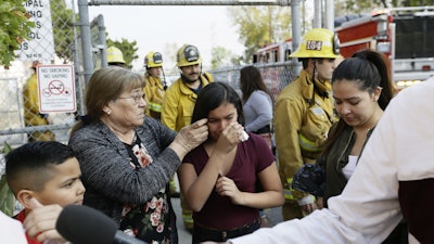 Student Marianna Torres, 11, center, cries as she evacuates Park Avenue Elementary School after jet fuel fell on the school in Cudahy, Calif., Jan. 14, 2020.
