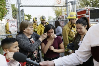 Student Marianna Torres, 11, center, cries as she evacuates Park Avenue Elementary School after jet fuel fell on the school in Cudahy, Calif., Jan. 14, 2020.