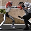 The Unitree G1 robot plays boxing with Aadeel Akhtar CEO and Founder of Psyonic at the first International Humanoid Olympiad at the Olympic Academy, in ancient Olympia, Greece, Monday, Sept. 1, 2025.
