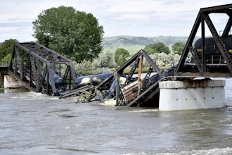 Train cars are immersed in the Yellowstone River after a bridge collapse near Columbus, Mont., June 24, 2023.