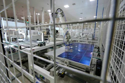 A robot places solar cells on a glass panel at a ReNew manufacturing plant on the outskirts of Jaipur, India, Thursday, Aug. 21, 2025.