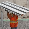 A construction worker carries steel decking at the site of a construction of a housing project, Thursday, July 31, 2025, in Portland, Maine.