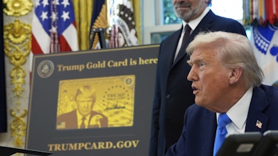President Donald Trump speaks as Commerce Secretary Howard Lutnick listens in the Oval Office of the White House, Friday, Sept. 19, 2025, in Washington.