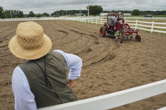 MK Bashar, right, test drives an electric tractor as Ben Phillips, left, watches Tuesday, Aug. 19, 2025, during a demonstration in East Lansing, Mich.