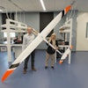 John Bird, Ph.D., and Afroza Shirin, Ph.D., stand with a model aircraft used in their research on soaring.