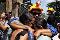 A miner embraces his relatives after he was rescued from a gold mine that had collapsed in Segovia, Colombia, Wednesday, Sept. 24, 2025.