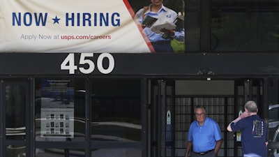 A hiring sign is displayed at a post office in Schaumburg, Ill., Sept. 18, 2025.
