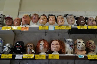 A variety of face masks line the shelves at the House of Humor costume shop in Redwood City, Calif., Thursday, Sept. 18, 2025.