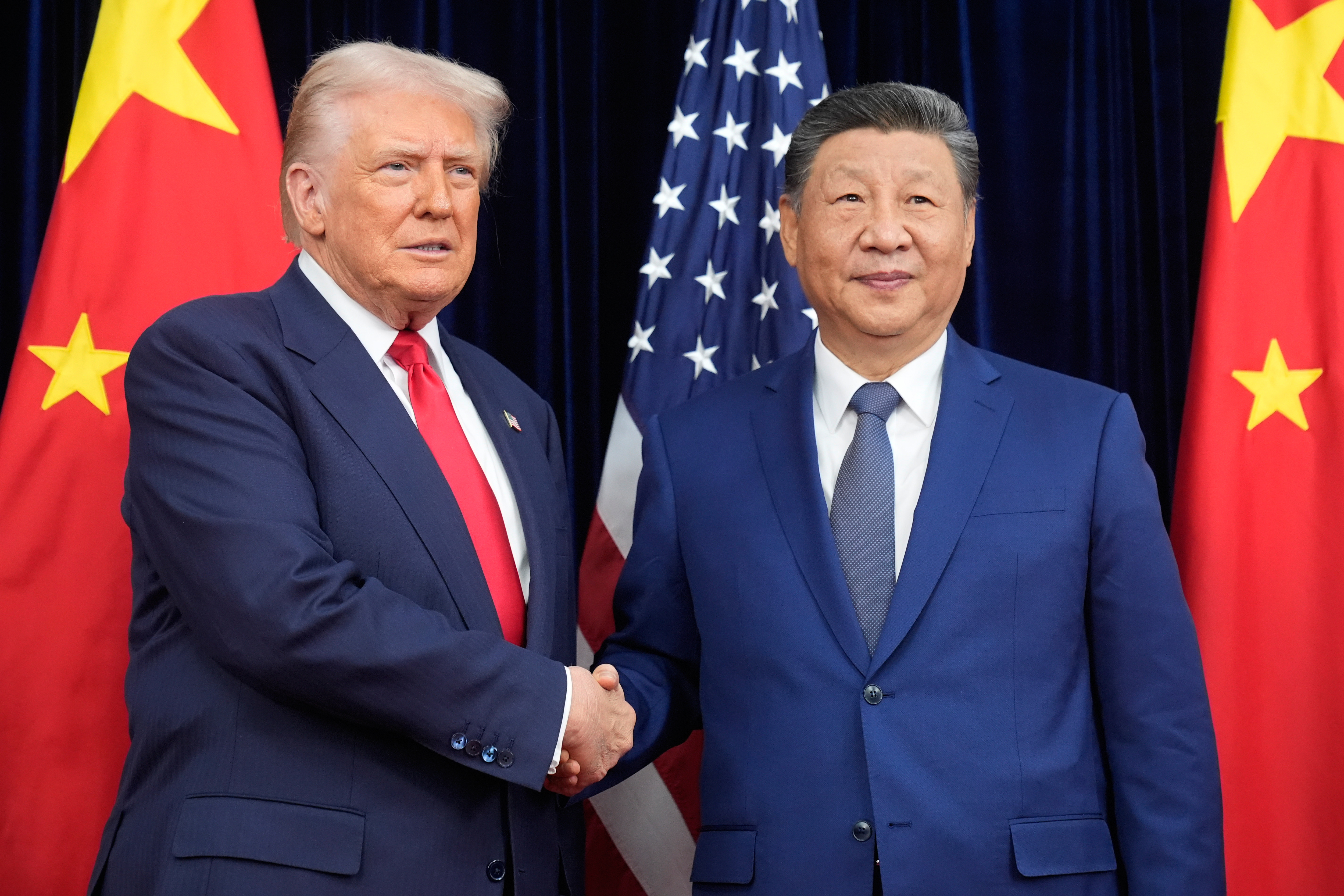 President Donald Trump and Chinese President Xi Jinping shake hands before their meeting at Gimhae International Airport in Busan, South Korea, Oct. 30, 2025.