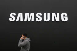 A person walks by a logo of Samsung Electronics at an exhibition hall for the Asia-Pacific Economic Cooperation (APEC) in Gyeongju, South Korea, Thursday, Oct. 30, 2025.
